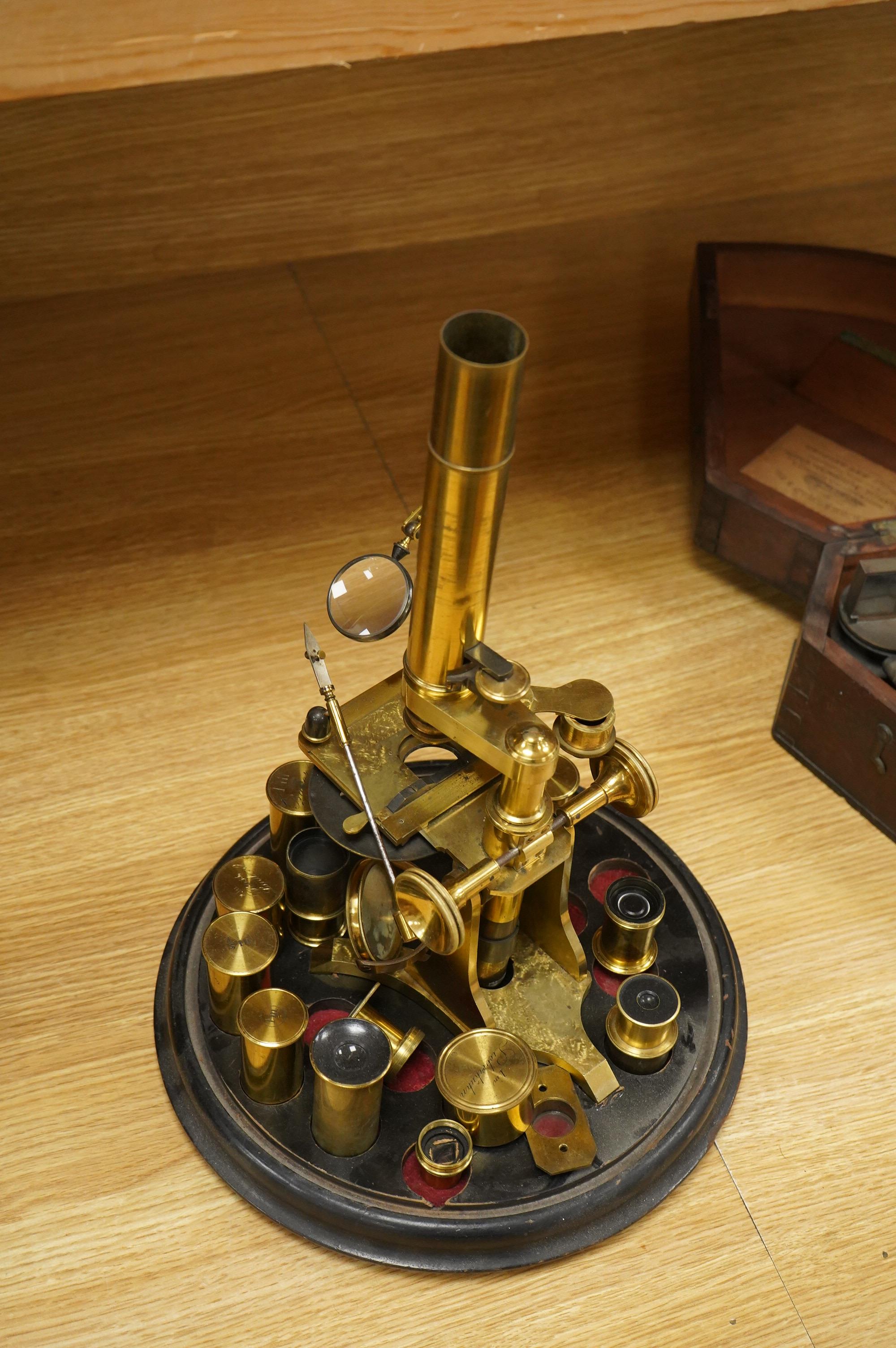 A mid 19th century brass monocular microscope, unsigned, with five objectives and three eyepieces, together with a Lieberkühn, a dark spot substage condenser, and a pair of Nicols prisms